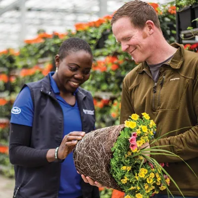 worker helping man with plant